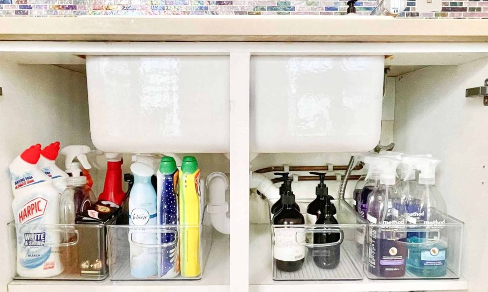homefulness-luxury-home-organising-cabinet-organisation A kitchen sink with a sink and a sink full of cleaning supplies.